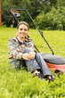 Young beautiful woman gardening and trimming the lawn