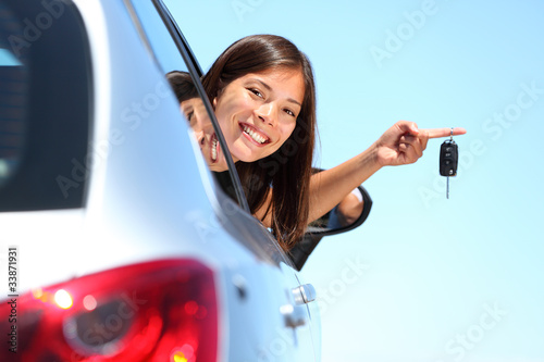 Photo: Driver woman showing new car keys Driver woman showing new car keys