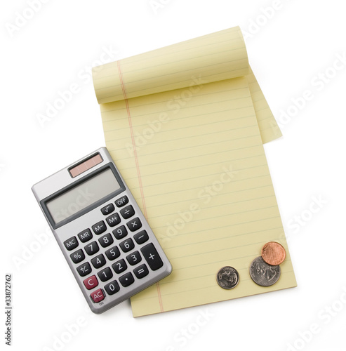 Photo: notepad,calculator and coins isolated on white notepad,calculator and coins isolated on white