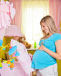 Pregnant woman in baby room