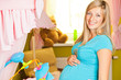 Pregnant woman in baby room