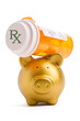 Piggy bank lifting a prescription medicine bottle on white