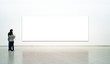 Couple of visitors on the exhibition looking at white picture