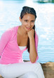 Young woman's face as she sits outside lake background