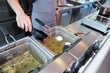 Chef cooking dish in a deep fryer Chef cooking dish in a deep fryer