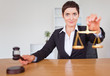 Serious woman with a gavel and the justice scale