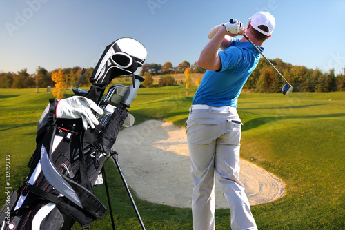 Photo: Man playing golf with golf bag Man playing golf with golf bag