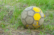 Photo: Old football (soccer ball) on an old neglected field. Old football (soccer ball) on an old neglected field.