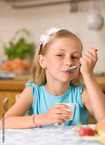 Photo: girl eating yoghurt girl eating yoghurt