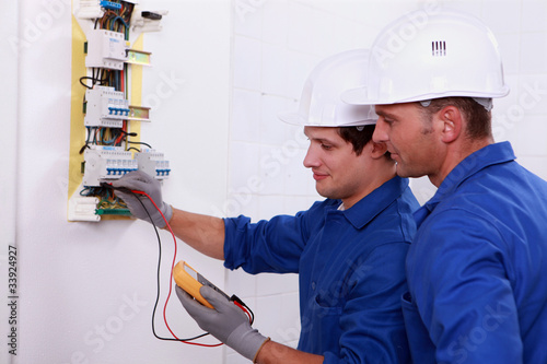 Photo: Two electricians performing checks Two electricians performing checks