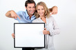 couple holding a frame