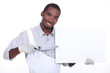 Man pointing a knife at a board left blank for your message
