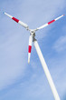 Wind turbine in blue sky.