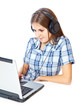 Red-haired teen-girl listen to music in headphones with laptop
