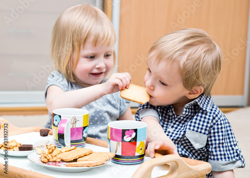Photo: Funny children are eating dessert Funny children are eating dessert