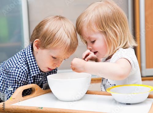 Photo: Funny children are eating dessert Funny children are eating dessert