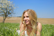 Photo: Young woman lying in grass in spring time Young woman lying in grass in spring time