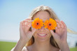 Photo: Young Woman holding flowers before her eyes Young Woman holding flowers before her eyes