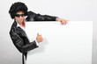 Man dressed as Elvis holding message board