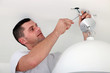 Man fixing light at home