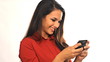 Young businesswoman sending text message and laughing
