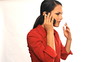 Young serious latina businesswoman on mobile phone