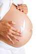 Pregnant woman moisturising belly to avoid stretch marks