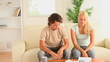 Worried couple looking at their expenses
