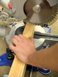 man cutting wood on electric saw