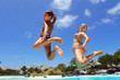 boy with mum jumping into the pool smiling boy with mum jumping into the pool smiling