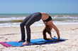 Photo: woman doing yoga exercise full wheel pose on beach woman doing yoga exercise full wheel pose on beach