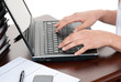 Hands typing on the laptop computer keyboard