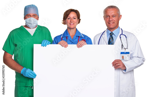 Photo: Medical team holding a blank poster isolated Medical team holding a blank poster isolated