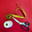 sewing tools on red background