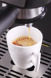 coffee expresso being poured into a mug