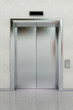 Front view of a modern elevator in a lobby with closed doors