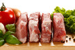 Raw pork on cutting board and vegetables