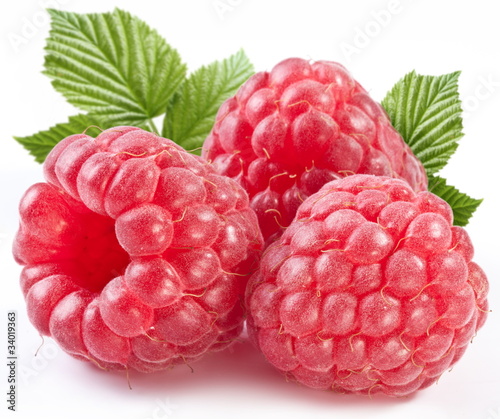 Photo: Three perfect ripe raspberries with leaves. Three perfect ripe raspberries with leaves.