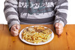 fat man eating a bunch of steaks and french fries