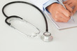 Female doctor writing on a scratchpad