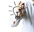 hand with a pen drawing light bulb
