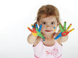 Little adorable girl playing with colors at home