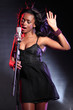 Beautiful black singer on stage with microphone