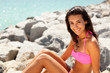 Pretty young brunette woman enjoying the beach