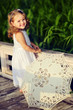 pretty little girl walking in the park with sun umbrella