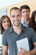 Portrait of student standing with workgroup