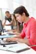Student in class using laptop computer