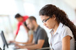 Portrait of smiling student in front of laptop computer