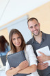 Portrait of college students standing in college hall