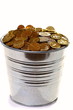 Zinc bucket of gold coins on a white background.